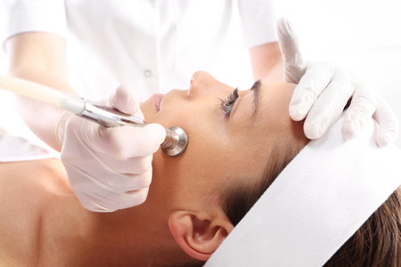 Relaxed woman during a microdermabrasion treatment in beauty salonの写真素材