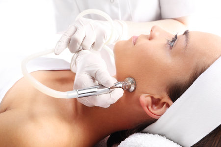 Relaxed woman during a microdermabrasion treatment in beauty salonの写真素材
