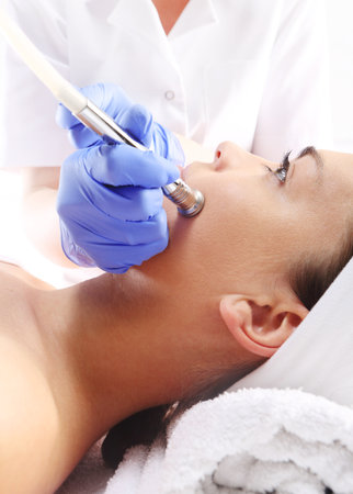 Relaxed woman during a microdermabrasion treatment in beauty salonの写真素材