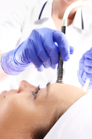 Relaxed woman during a microdermabrasion treatment in beauty salonの写真素材