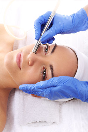 Relaxed woman during a microdermabrasion treatment in beauty salonの写真素材