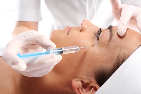 Caucasian woman during surgery using a scalpelの写真素材