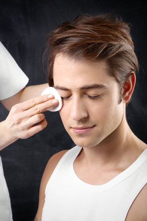 Young handsome man during the treatment of facial skin treatmentの写真素材