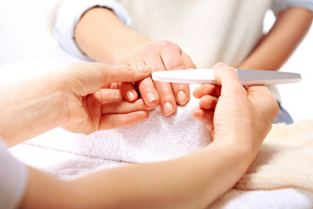 Nail sawing a woman in a beauticianの写真素材
