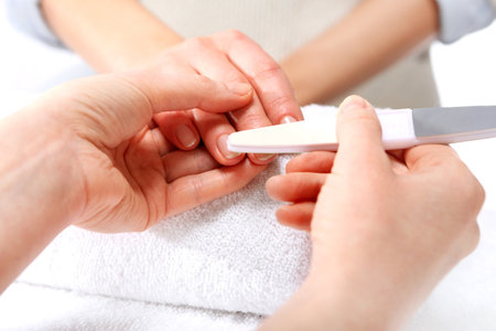 Nail sawing a woman in a beauticianの写真素材