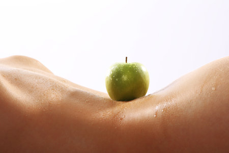 A flat stomach, firm breasts, fruit and vegetable dietの写真素材