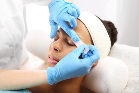 Hair removal, eyebrow regulation wax in the beauty salonの写真素材