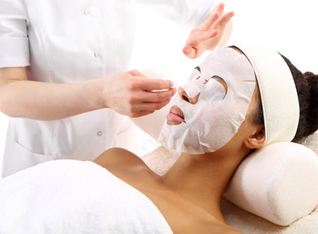 Cleansing facial skin, a woman in beauty salonの写真素材