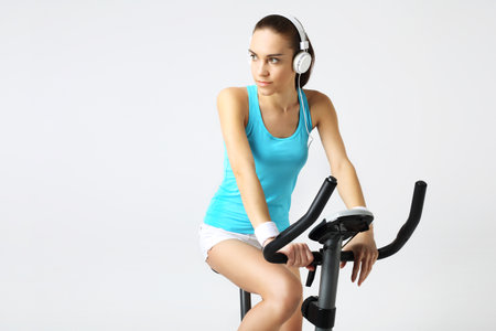 Exercise on a stationary bike, a woman in a fitness clubの写真素材