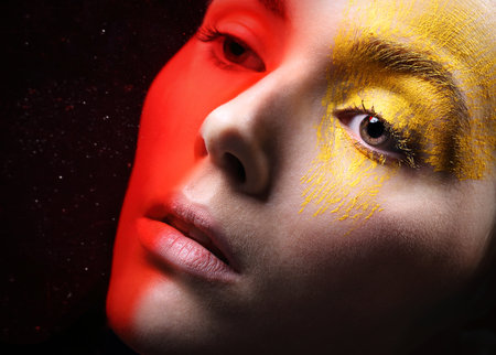 Fiery eye makeup - energy and passion.Portrait, close-up on the face of a woman in a fancy makeup.の写真素材