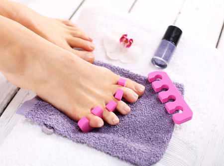 Purple pedicure, groomed female footの写真素材