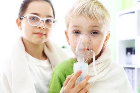 Cold or flu? Siblings inhalation during home treatmentの写真素材