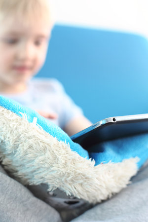 Preschooler playing games on a digital tabletの写真素材