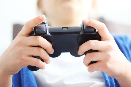 Gamepad, video game. Child holding a remote control in his hand video games.の写真素材