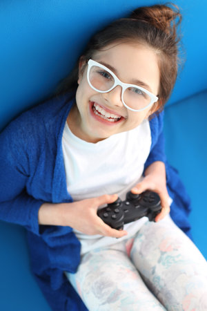 Child holding a remote control in his hand video games.の写真素材