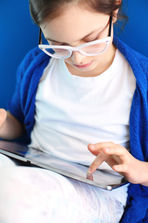 The girl, a teenager draws on a digital tabletの写真素材