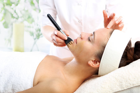 Cosmetic moisturizing mask is applied to the face of a womanの写真素材