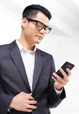 Office worker, businessman dials the phone number on the phone keypad.の写真素材