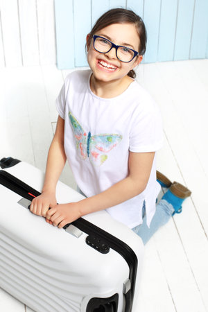 How to pack a suitcase Girl suitcase packed with things for a holiday tripの写真素材