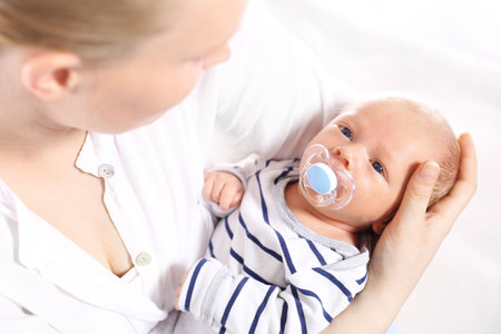 I39m safe with you. A woman holds in her arms her newborn babyの写真素材