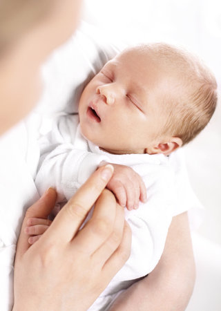 A mother39s love. A woman holds in her arms her newborn babyの写真素材
