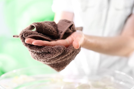 Beautiful hands. The woman wiped her hands with a towelの写真素材
