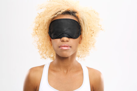 Restful sleep. Young woman with eyes blindfolded band on eyesの写真素材