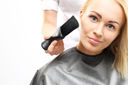 Brush hairdresser. Barber sweeps hair with arms clientの写真素材