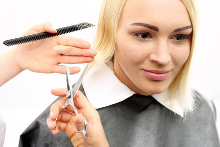 Hairdresser. Barber haircut woman in a hair salonの写真素材