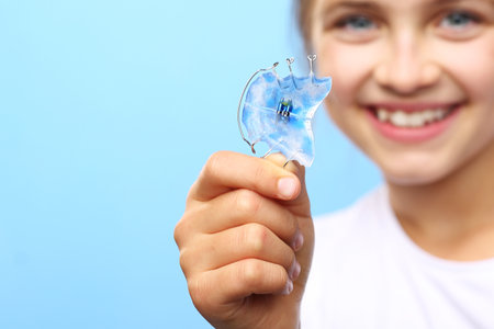 Orthodontics. Portrait of a little girl with orthodontic appliance.の写真素材