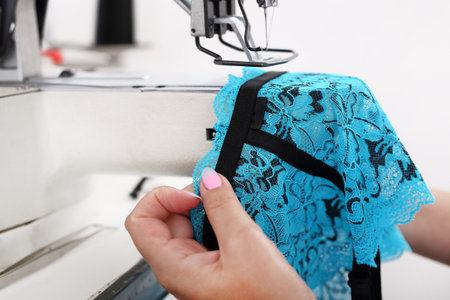 Sewing machine. Seamstress sewing on the sewing machine in the manufacturing plantの写真素材