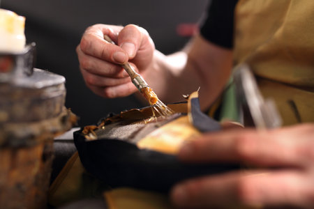 Shoe repair. shoemaker performs shoes in the studio craftの写真素材
