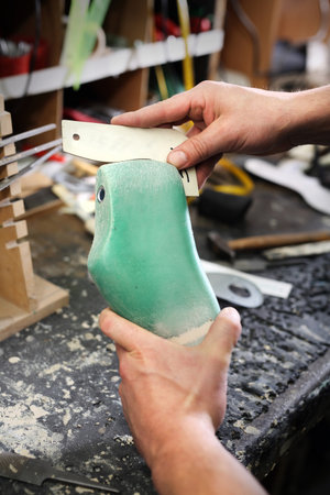 Shoemaker. Cobbler shoemaker sews elegant shoesの写真素材