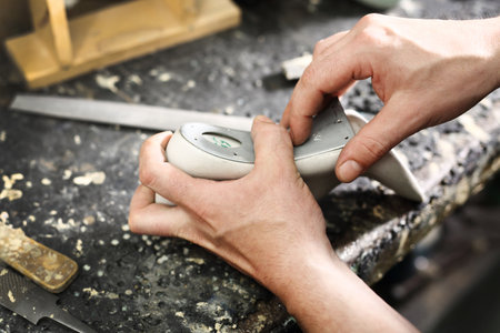 Shoemaker. Cobbler shoemaker sews elegant shoesの写真素材