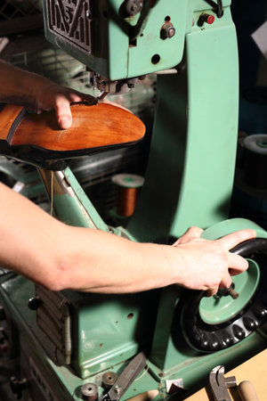 Shoemaker sews shoes. Shoemaker manually performs shoes in the studio craftの写真素材