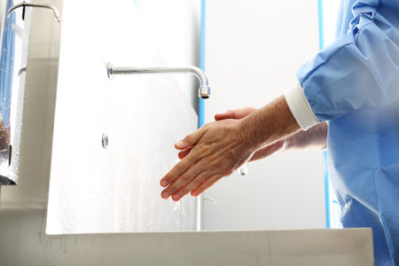 The doctor disinfects his hands. The doctor washes his hands, disinfect Their hands before surgeryの写真素材