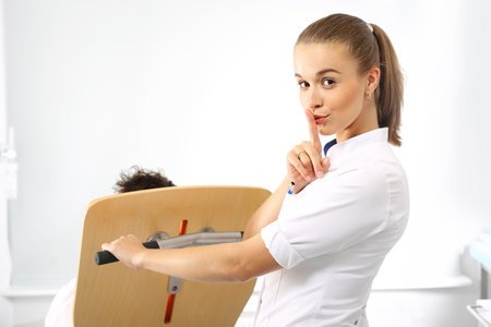 A nurse tends to a patient. nurse carries a patient in a wheelchair.の写真素材