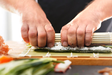 Slicing sushi with crab, salmon, cucumberの写真素材