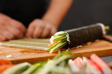 Sushi Master prepares futomakiの写真素材