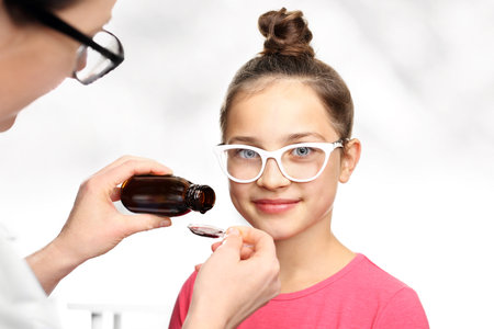Your child is taking a drug Administered on a spoon.の写真素材
