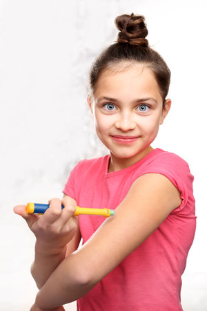 Girl with diabetes during the injections of insulin.の写真素材