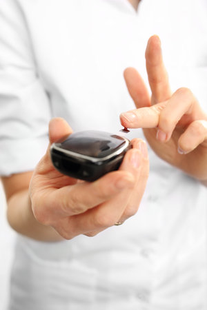 Glucometer. Measuring the level of sugar in the bloodの写真素材