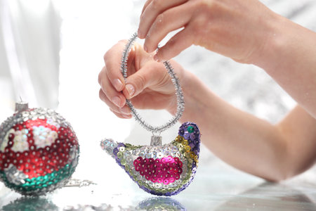 Woman performs Christmas tree ornaments. の写真素材