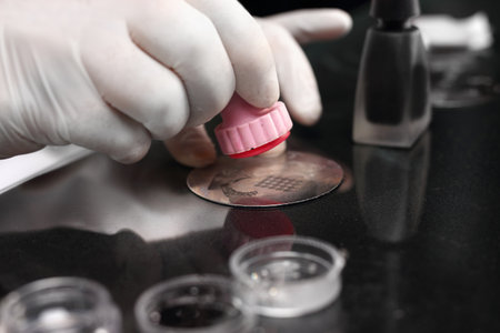 Beautician Applies the lacquer on the nail stamping lamellaeの写真素材
