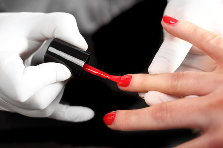 Red nail polish, colored manicure, cosmetic colored lacquer painting nailsの写真素材