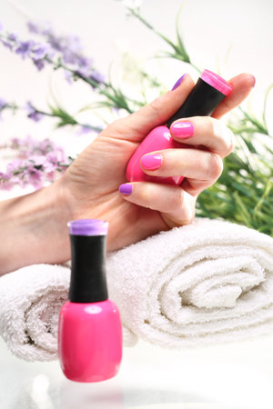 Pastel pink nail polish nails. Colored manicure, cosmetic colored lacquer painting nailsの写真素材