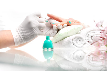 Hybrid manicure and beauty salon. Colored manicure, cosmetic colored lacquer painting nailsの写真素材