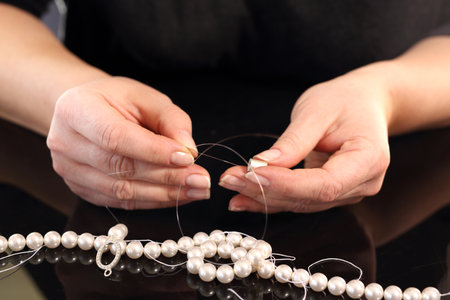 Threading beads. Pearl beadsの写真素材