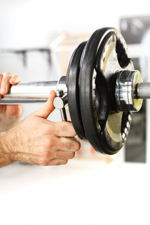 Trainer in the gym, training with weightsの写真素材