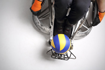 Sport for the disabled. The man on the sports wheelchair with the ballの写真素材